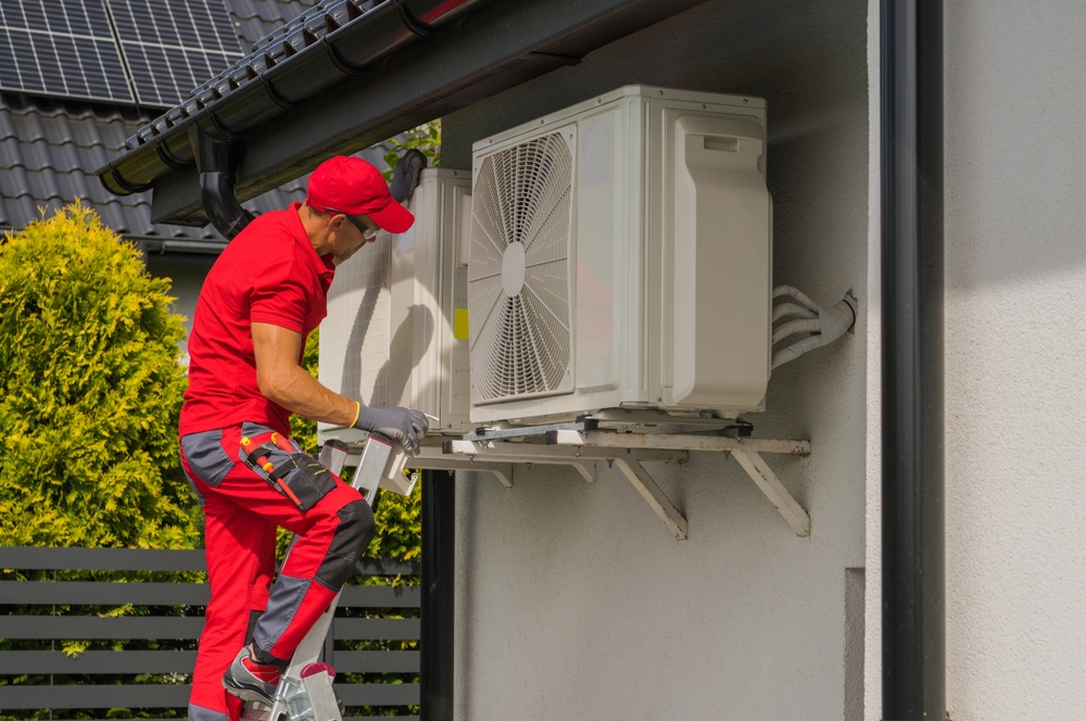 HVAC technician inspecting a heat pump