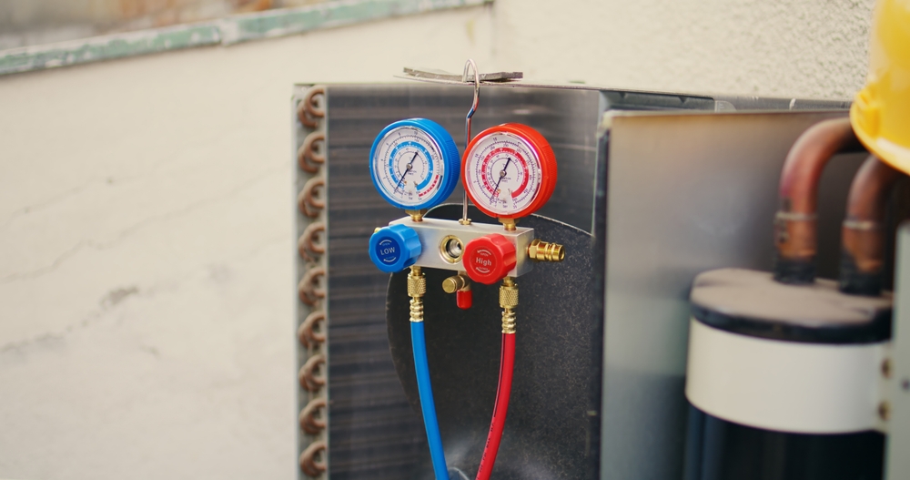 Using manifold gauge to check AC refrigerant levels